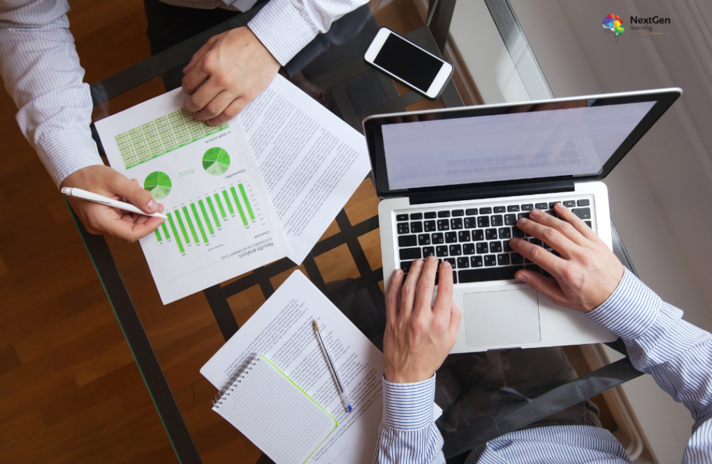 Professionals Reviewing Charts and Laptop