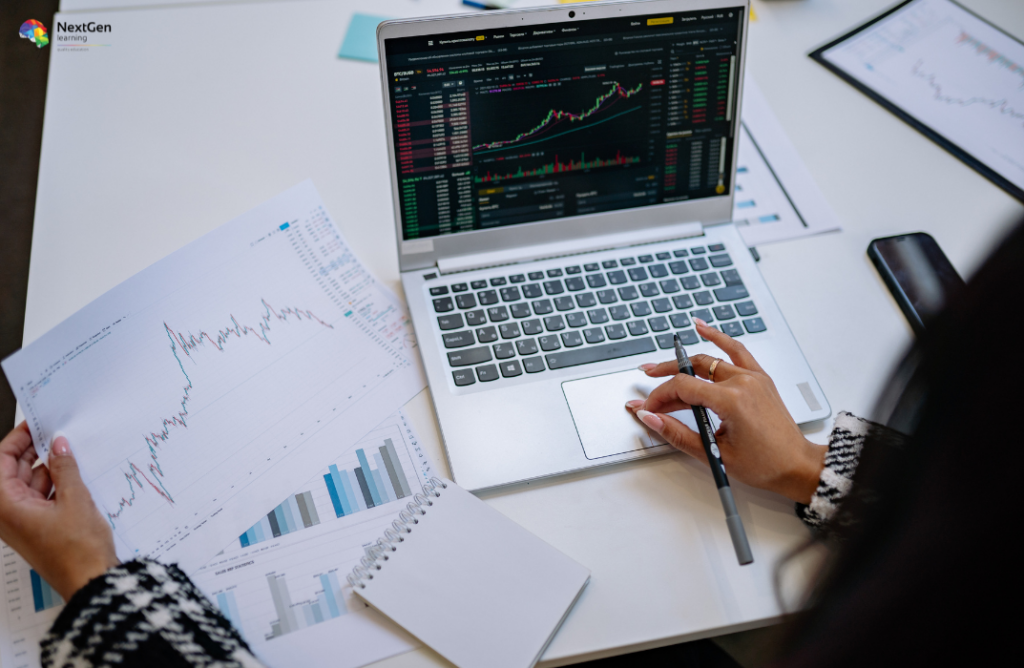 Laptop with Trading Charts and Printed Graphs