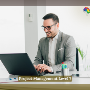 A cheerful professional man wearing glasses and a grey suit is seated at a modern desk, working on a laptop in a bright, minimalist office space. A small plant, stationery, and documents are neatly arranged on the desk. The logo of "NextGen Learning" is visible in the top-right corner, and a text overlay at the bottom reads "Project Management Level 7".