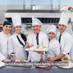 A group of chefs smiling in a kitchen, holding plated dishes and wearing chef uniforms.