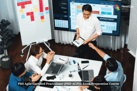 Team discussing agile project plans during a meeting with charts, laptops, and a presentation board — representing the PMI Agile Certified Practitioner and Agile Project Management Course.