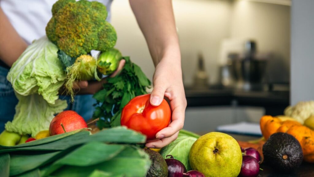 Vegetables in female hands the concept of food preparation in the kitchen
