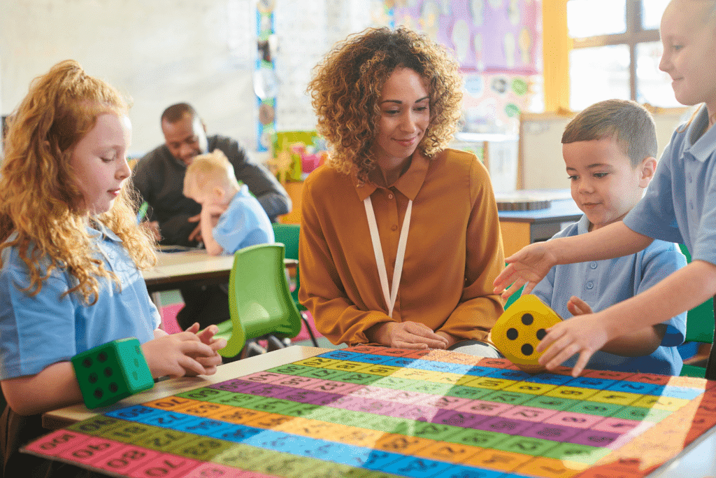 Classroom activity with children learning math using colorful number grid and foam dice under Reggio Emilia approach