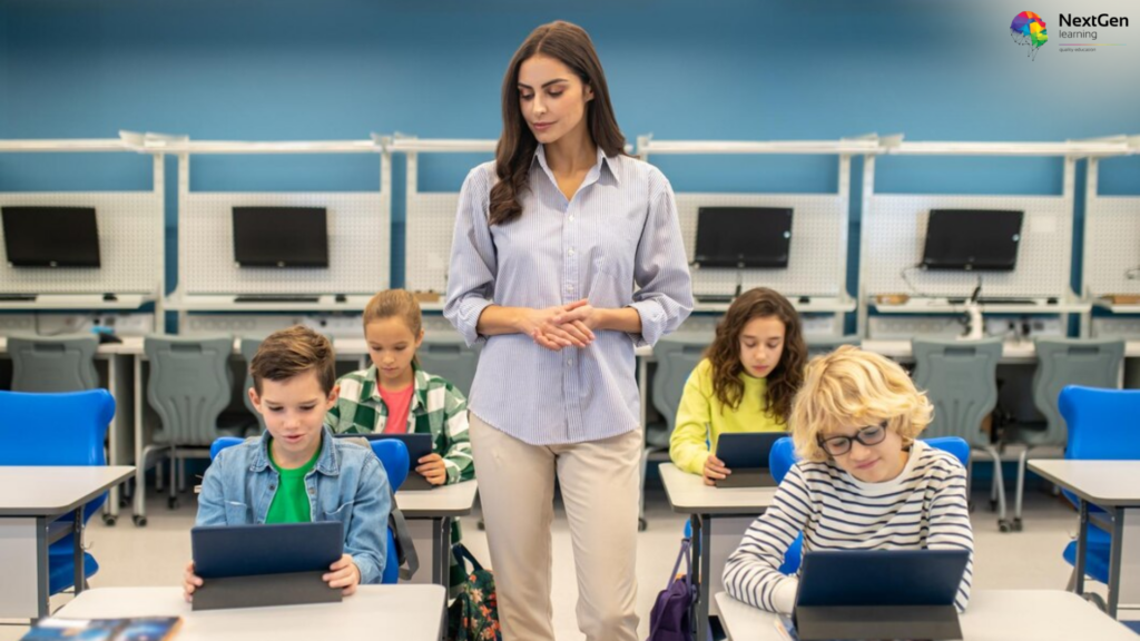 A teacher supervises a diverse group of young students using tablets in a modern classroom, featuring the NextGen Learning logo in the corner.