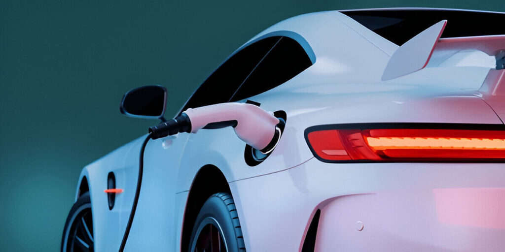 Electric sports car charging at station with rear view and connected power cable.