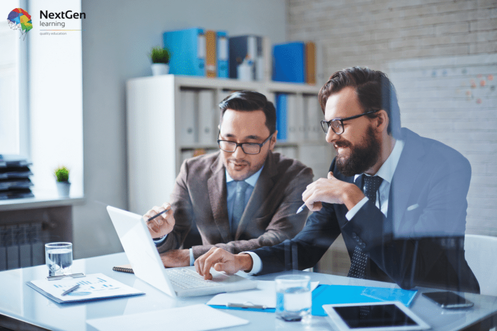 Image showing management consultants in a modern office collaborating over a laptop with charts, documents, and digital tools, symbolising careers in business strategy, problem‑solving, and organisational growth.